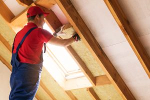 Man insulating the attic of a home