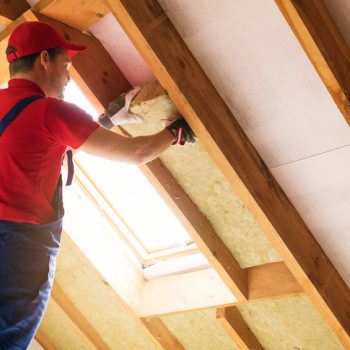 Man insulating the attic of a home