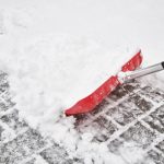 shoveling snow off roof in the winter