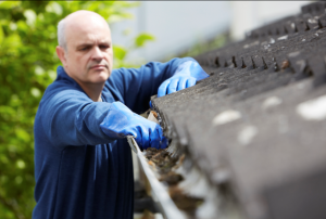 Man cleaning gutters