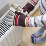 Warming up hands by radiator