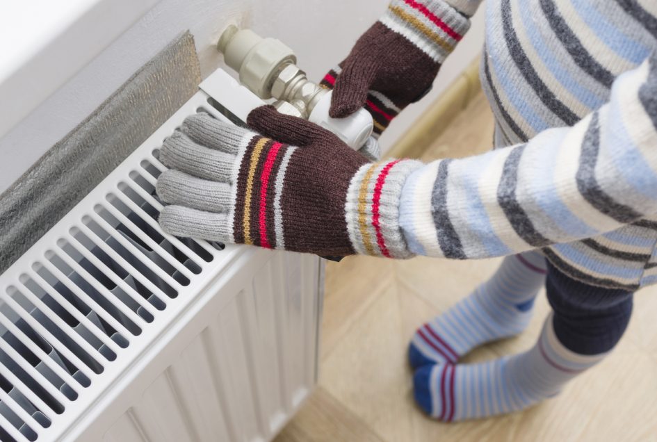 Warming up hands by radiator