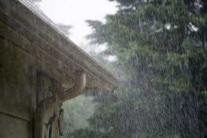 Heavy rainstorm pouring down on gutters