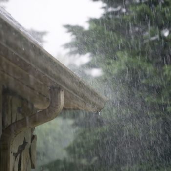 Heavy rainstorm pouring down on gutters